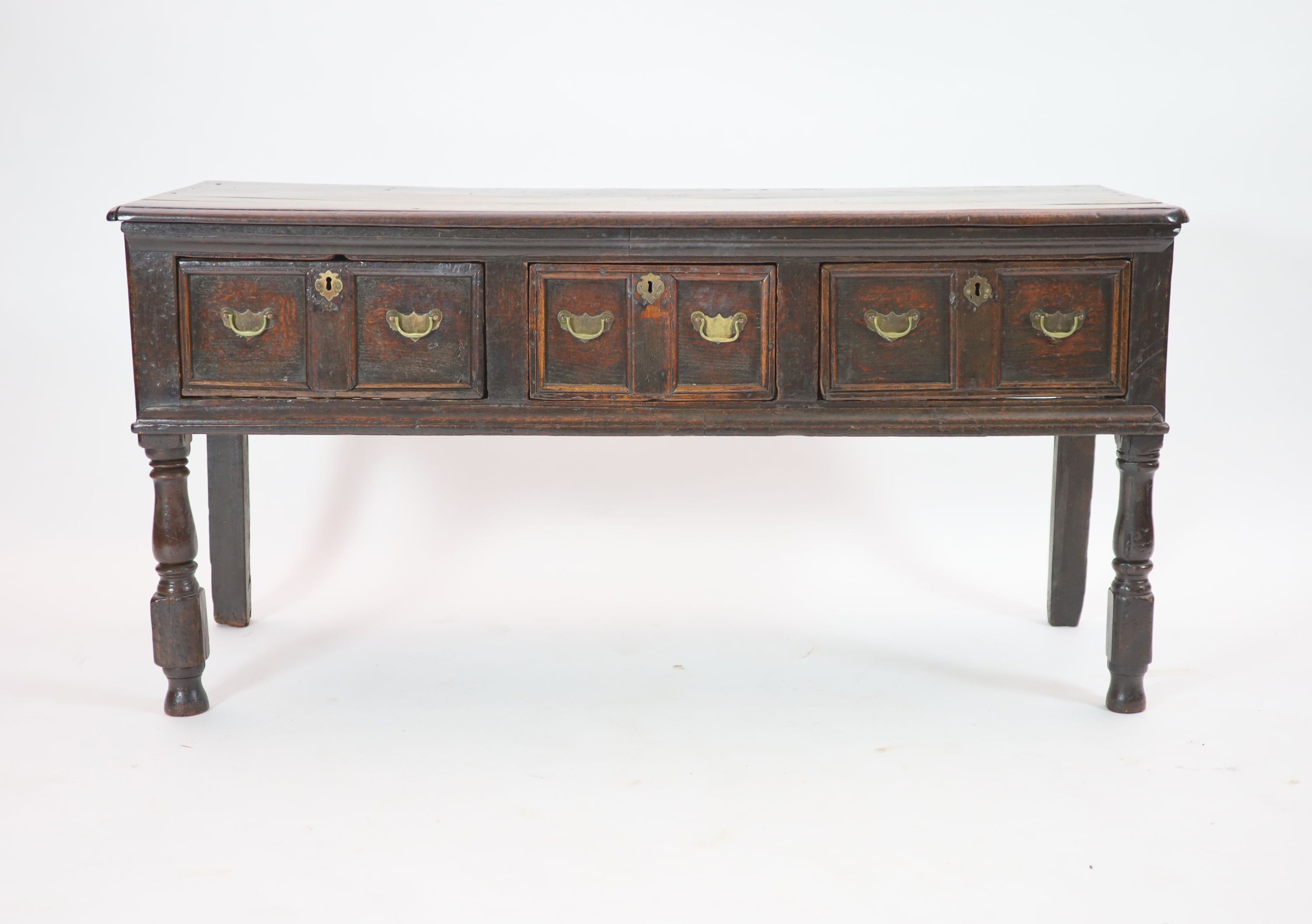 A late 17th century oak low dresser H 76cm. W 154cm. D 54cm.